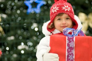 young child holding a christmas present